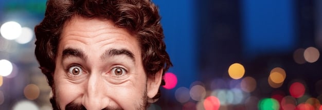 A close-up shot of someone's face expressing shock and disappointment, with a blurred background representing a movie scene. The lighting should be dramatic, contrasting light and shadow to emphasize the emotions.