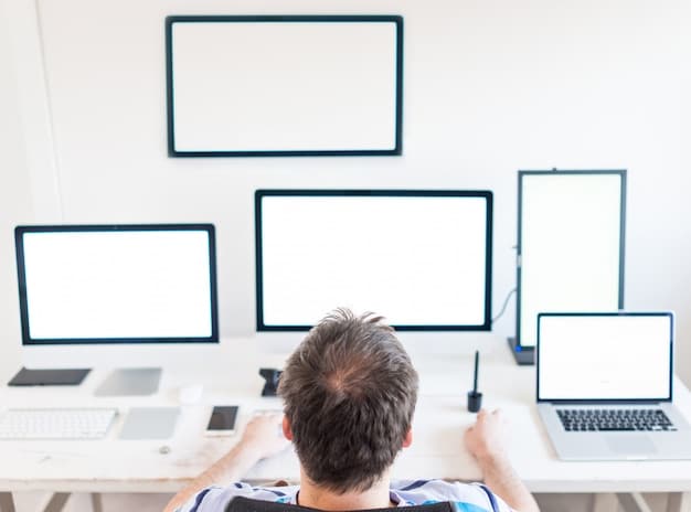 A person sitting at a desk with a laptop, surrounded by multiple screens displaying various scenes from popular TV shows. The room is dimly lit, with a single desk lamp illuminating their workspace, emphasizing the intensive research and analysis involved in crafting episode recaps.