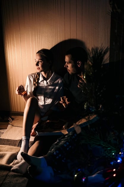 A still from Euphoria featuring Rue, Jules, and Elliot sitting together in a dimly lit room, conveying tension and discomfort. Their facial expressions hint at the complex and conflicted emotions between them.