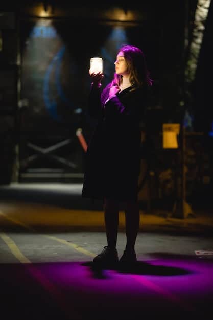 A scene from Euphoria showing Lexi on stage during her play, looking nervous but determined, illuminated by the stage lights. The audience's blurred faces hint at their reactions to her performance.