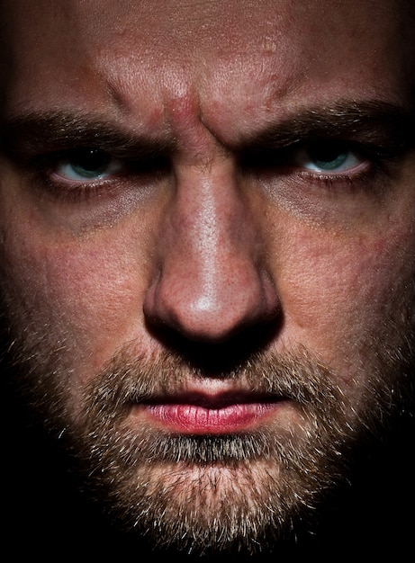 A close-up shot of a character's face, filled with determination and a hint of desperation, as they face a critical decision point in the episode. The background is blurred to emphasize the character's emotional state.
