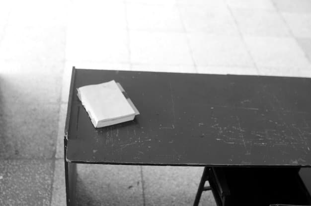 A close-up of a desk on the severed floor. The image focuses on the details: the type of computer, the minimalist design, and any subtle objects placed on the desk. This image should evoke a sense of isolation and psychological manipulation through the environment.