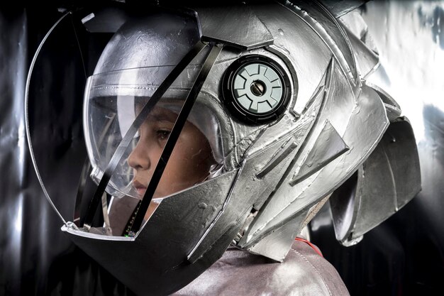 A close-up of Din Djarin's helmet reflecting the image of Grogu sitting in the cockpit of the Razor Crest. The image captures the emotional bond between the characters and their shared journey through the galaxy.