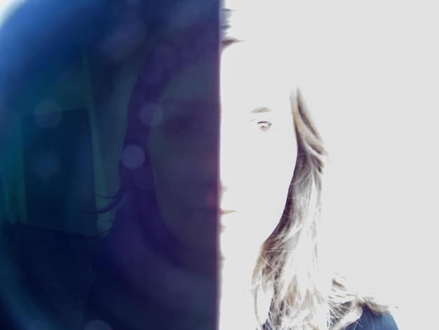 A split-screen image showing the stark contrast between a person's real life and their heavily-filtered, idealized online persona. The real-life side is drab and ordinary, while the online persona is glamorous and seemingly perfect.